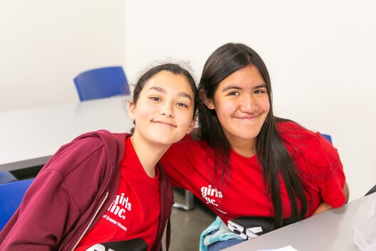 young girl using a tool to tighten a part